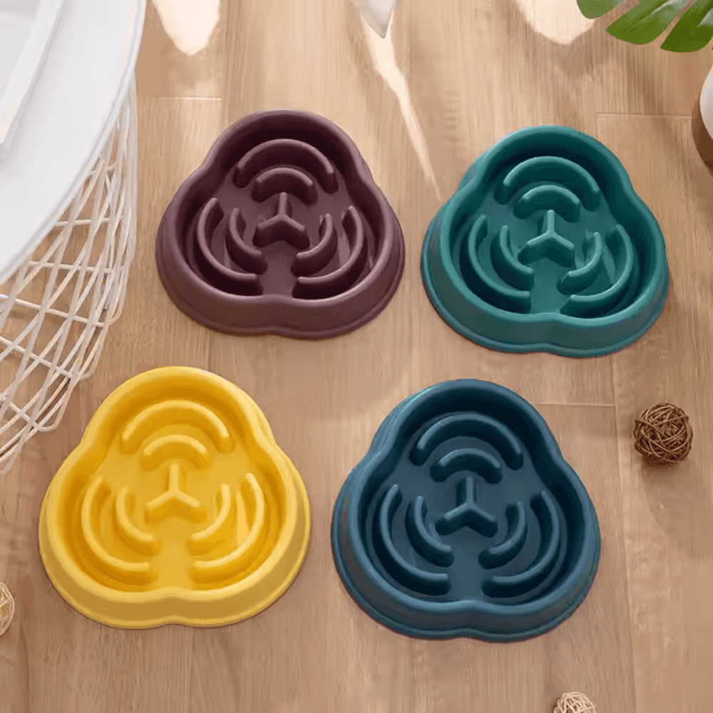 Non-slip slow feeder dog bowls in four colors—yellow, teal, purple, and blue—made of silicone with maze design to reduce fast eating.