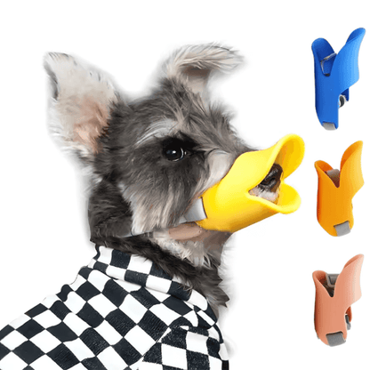 Dogs Anti Bite Stop soft silicone duck-bill muzzle in yellow, worn by a Schnauzer. Available in multiple colors for pet safety and comfort.