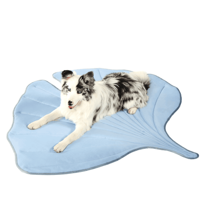 Dog stretched out on blue Leaf-Shaped Cooling Pet Mat. Stylish pet bed for cooling and comfort in warm climates.