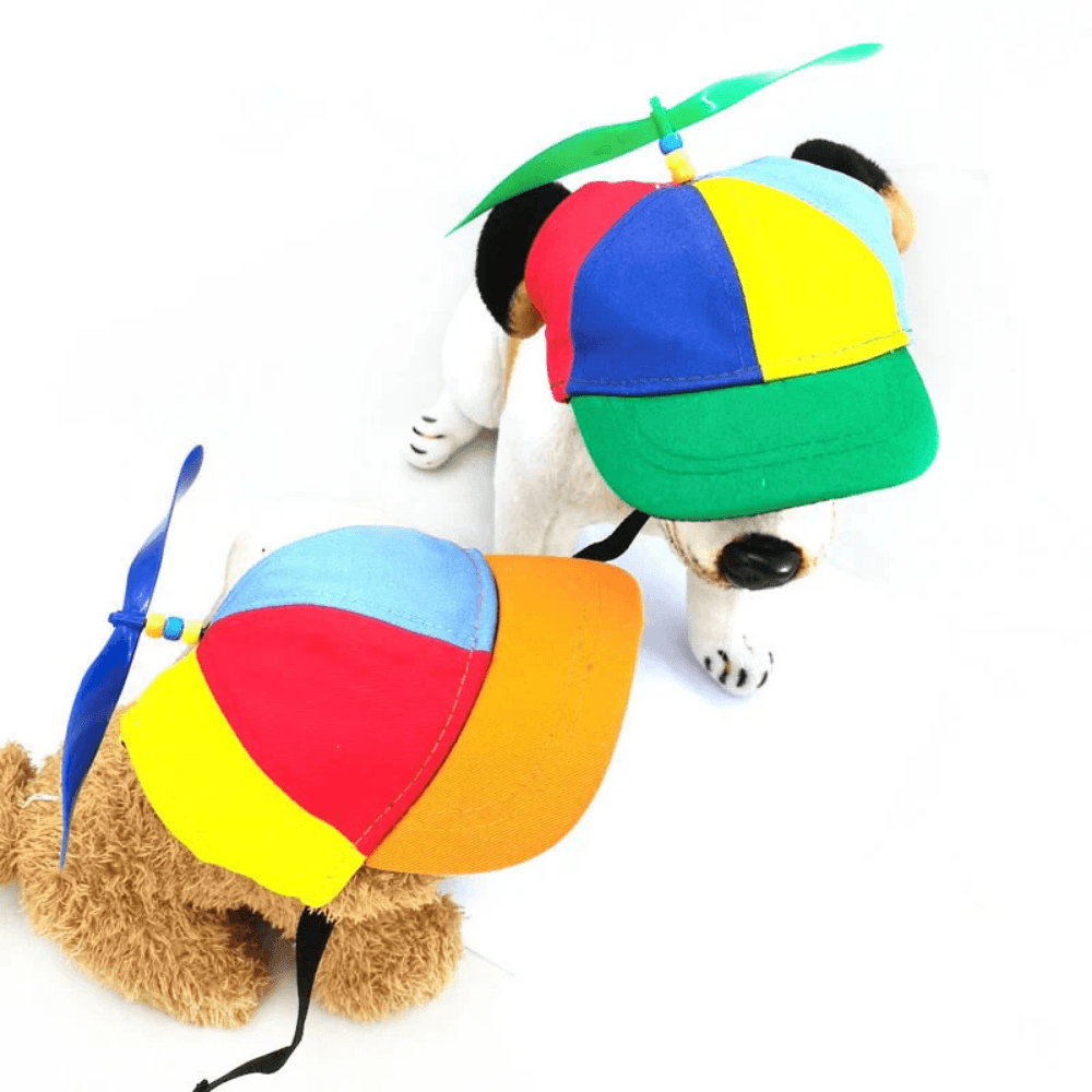 Two vibrant Funny Dog Propeller Hats in multicolor panels with spinning tops, perfect pet apparel for playful and sunny outings.